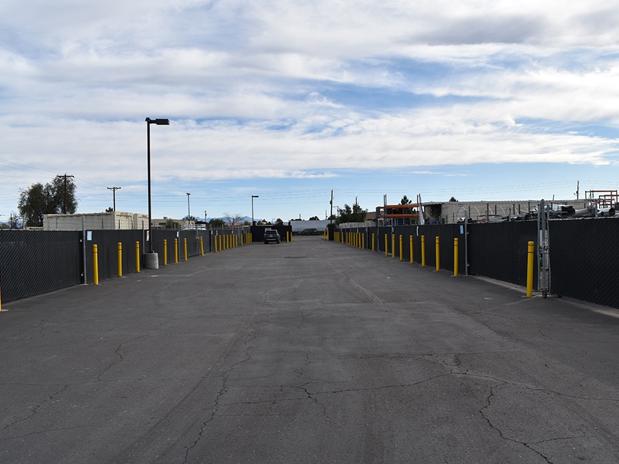 Secure contractor storage yard with safety bollards and lighting.